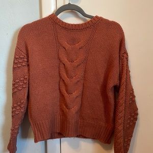 Burnt orange sweater.